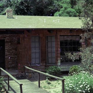 Rustic brick house with green roof.