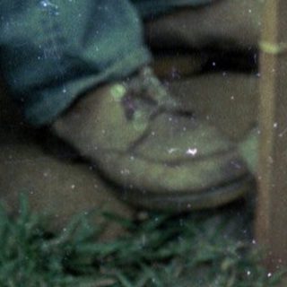 Man petting dog through glass door.
