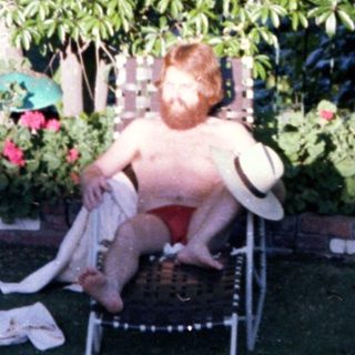 Child relaxing in outdoor lounge chair.