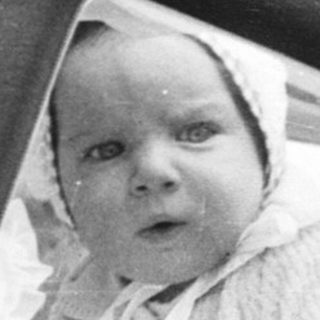 Vintage pram with baby portrait inset.