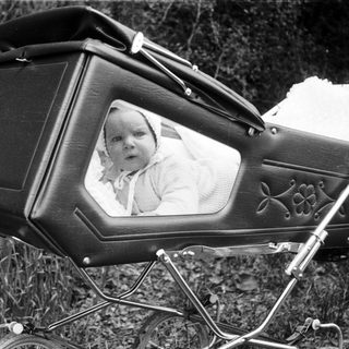 Vintage pram with baby portrait inset.