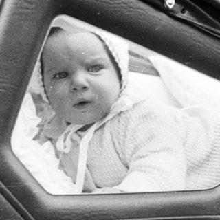 Vintage pram with baby portrait inset.