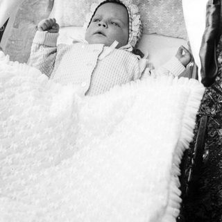 Baby peacefully sleeping in a stroller.