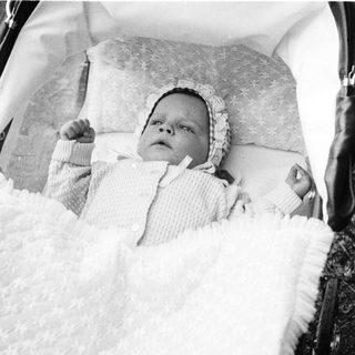 Baby peacefully sleeping in a stroller.