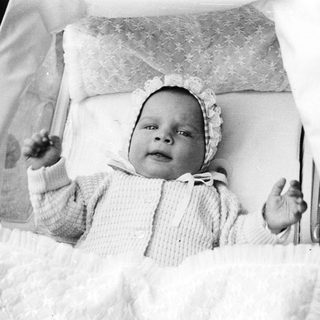 Baby in vintage pram, early 20th century.