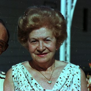 Happy elderly couple posing indoors at night.