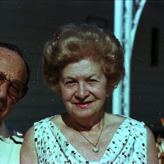 Happy elderly couple posing indoors at night.