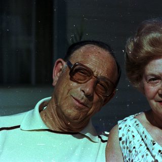 Happy elderly couple posing together indoors.