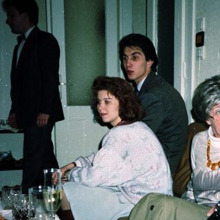 People gathered indoors at a formal event.