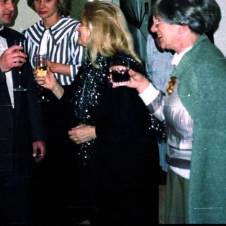 Group of people socializing indoors at an event.