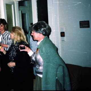 Group of people socializing indoors at an event.