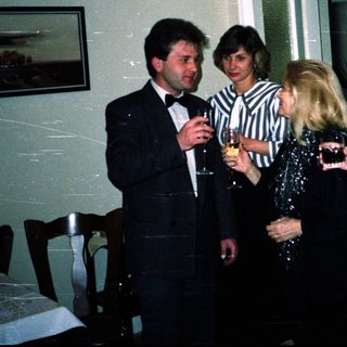 Group of people socializing indoors at an event.