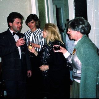 Group of people socializing indoors at an event.