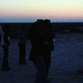 People stargazing or photographing night sky.