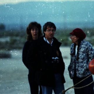 People standing near a hot air balloon.