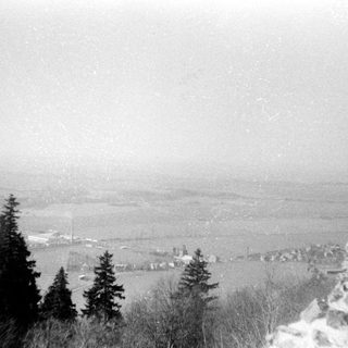 Snowy mountain landscape with valley below.