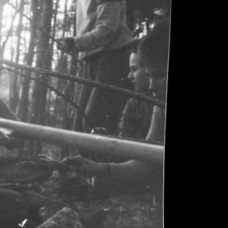Battlefield scene with soldier in trench under fire.
