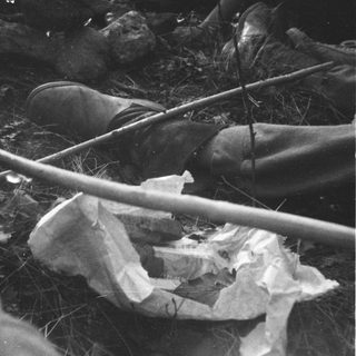 Trash and litter discarded on grassy area.