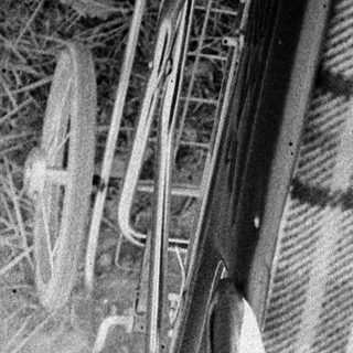 Baby sleeping in vintage pram with plaid blanket.