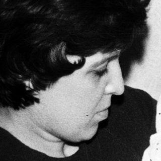 Woman feeding baby with bottle.