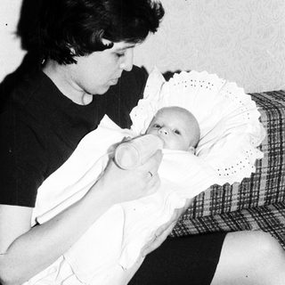 A woman breastfeeding an infant.