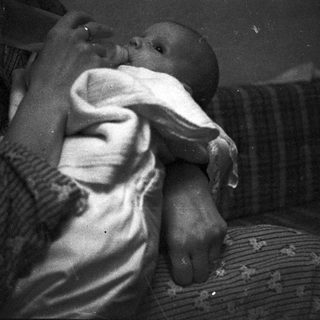 Tender moment of adult comforting sleeping child.