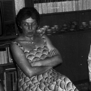 Two people sitting indoors, engaged in conversation.