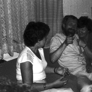 Family enjoying indoor gathering with laughter.