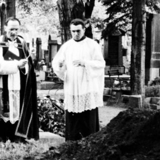 Religious funeral service at a cemetery.