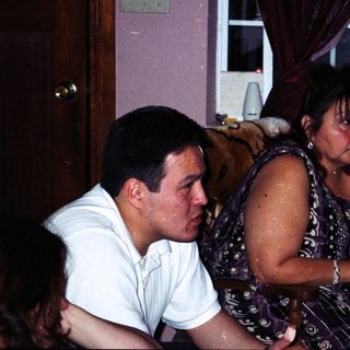 Two people sitting indoors, appearing distressed.