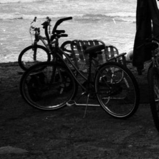 Camper van parked near ocean with bicycles.