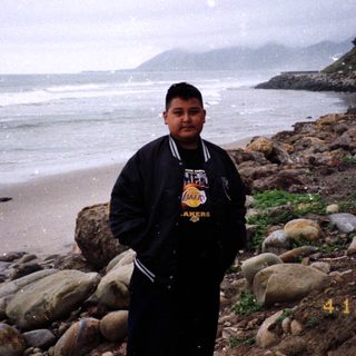 Person standing on beach near ocean on April 12, 2003.