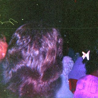 Crowded indoor event with blacklight and star-shaped marker.