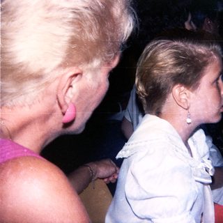 Two women in formal attire at an indoor event.