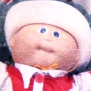 Plush toy seated inside large cabbage sculpture.