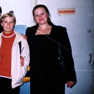 Group of five people standing near a doorway.