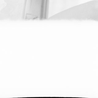 Black and white image with a blurred, white textured surface.