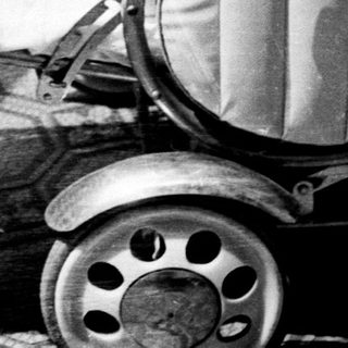 Baby sleeps peacefully in an antique baby carriage.