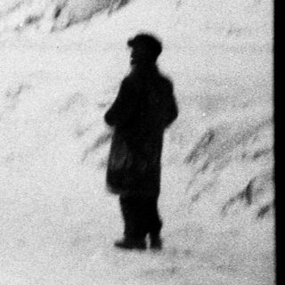 Man appears to be airborne in snowy landscape.