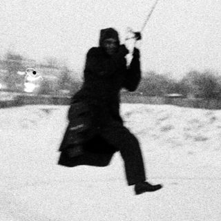 Man swings through the air on a rope in snow.