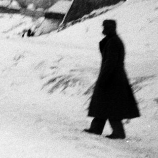 Here's a brief summary of the image: People walking and gesturing in a snowy, wintry landscape.