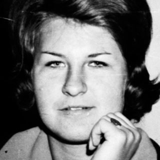 Black and white photo of a woman in a room.