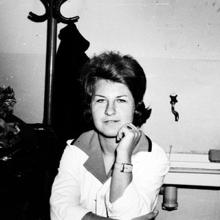 Black and white photo of a woman in a room.