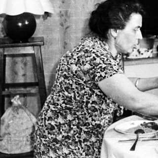 People dining at a table in a vintage home.