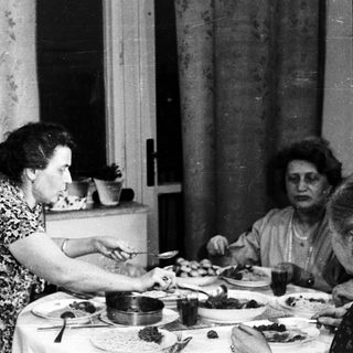 People dining at a table in a vintage home.