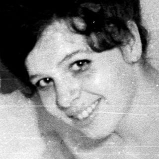 Woman in a bathtub, surrounded by bubbles.