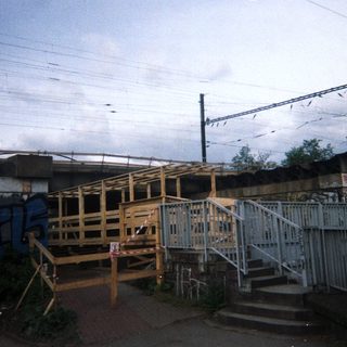 Underpass and railway infrastructure with graffiti and construction.