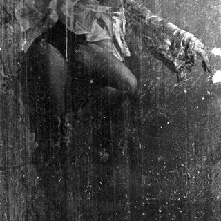 Here's a brief summary of the image: Figure in draped fabric, obscured in dark, textured monochrome.