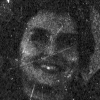 Faded, damaged image appears to show a person standing.