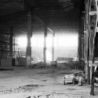 Black and white photo of an unfinished, industrial interior.